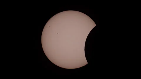 Timelapse of Partial Solar Eclipse with Sunspots in Black Sky Stock Footage 348132413