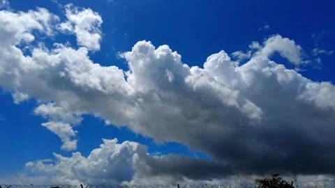 Timelapse of passing clouds with dark thundercloud at edge with blue sky Video stock 248952121