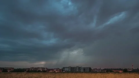 A timelapse of a passing storm cell over a city neighborhood with lightning. Stock Footage 301405101