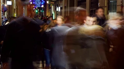 Timelapse of pedestrians walking at night in a small street in Barcelona, Spain. Stock Footage 69941261