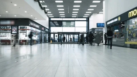 Timelapse people enter and exit through main entrance inside a mall. Guests Stockbeeldmateriaal 120349441