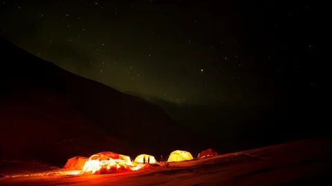 Timelapse of people moving around basecamp at night in high altitude mountains Stock Footage 124238656
