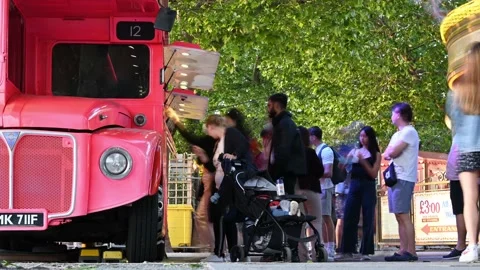 A TIMELAPSE of people queuing at a bright pink frozen yoghurt van on South Ba Video stock 159237396