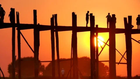 Timelapse of people walking over the u-bein bridge during sunset at mandalay Stock Footage 74532364