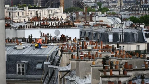 A timelapse of people working in the rain on a rooftop in Paris Stock Footage 197134027
