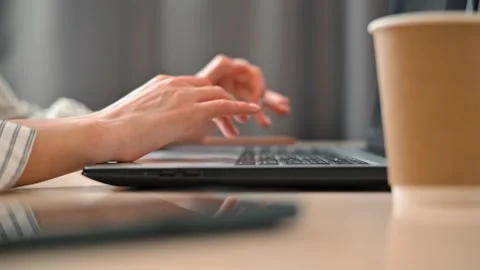 Timelapse person fast typing on a laptop while sitting at a desk in a home Stock Footage 339006016