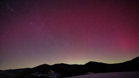 Timelapse of Pink Aurora Borealis Glowing Over Winter Mountain Range Stock Footage 336384429