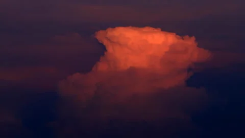 Timelapse pink clouds at sunset fly across the dark sky Stock Footage 156703373