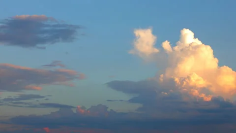 Timelapse pink clouds at sunset fly across the blue sky Stock Footage 156703798