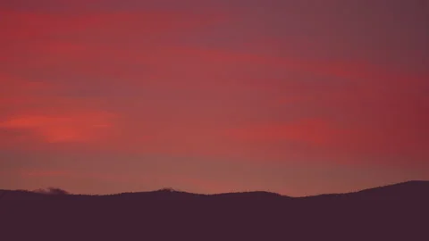 Timelapse of pink sunset clouds over the mountains Stock Footage 161379795