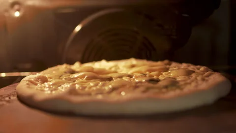 Timelapse of a pizza being cooked in the oven. Close-up melting cheese in 4K. Stock Footage 137484859