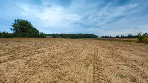 Timelapse of plowed field under cloudy sky Stock Footage 58888302