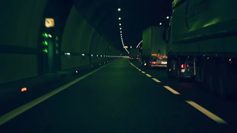 Timelapse point of view of vehicle overtaking many trucks in a tunnel Stock Footage 148121678