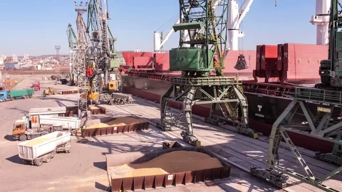 Timelapse of port cranes loading dry-cargo ship Stock Footage 105404320