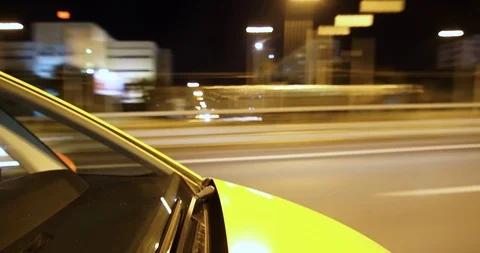 Timelapse pov on-board-camera on a hood of a car driving night city Taxi yelow Stock Footage 101874323