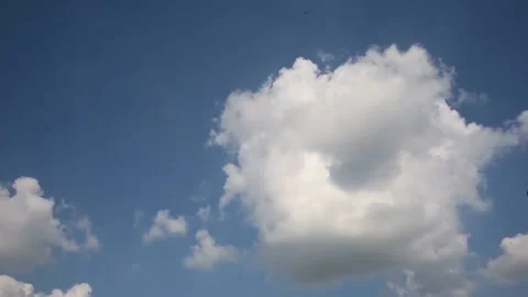 Timelapse of puffy fluffy rolling clouds in vast clear blue sky Stock Footage 152886975
