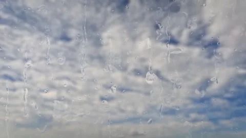 Timelapse of rain on beautiful blue sky with little clouds - loop video Stock Footage 276369841