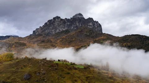 Timelapse of rainbow and clouds with autumn colours of Peña Foratata in the Pyre Stock Footage 164572183