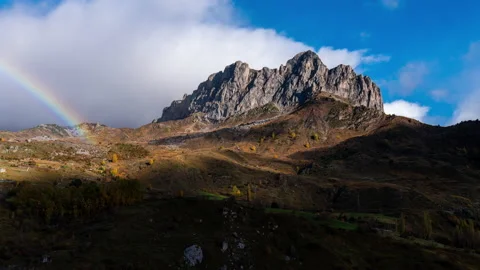 Timelapse of rainbow and clouds with autumn colours of Peña Foratata in the Pyre Stock Footage 164726815