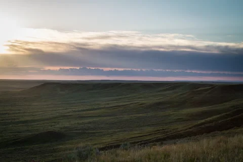 Timelapse of rays of light over grassland at sunrise in summer Stock Footage 62064362