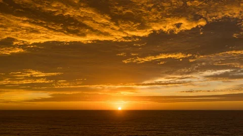 Timelapse of a Red and Golden Cloudy Sunrise Stock-Footage 129669979