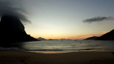 Timelapse of the Red Beach, with the Sugar Loaf to the left and a cloud cover Stock Footage 81139889