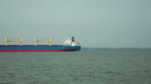 Timelapse of red cargo grain ship floats on the calm sea. Concept of delivering Stock Footage 197036703