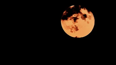 Timelapse of Red Full Moon with Passing Dark Clouds Stock Footage 322151197