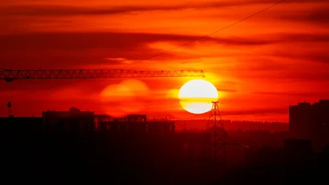 Timelapse red sunset against the dark silhouette of the city Stock Footage 128939494