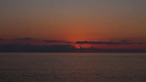 Timelapse of Red Sunset Over the Sea with the Sun Setting Below the Horizon Stock Footage 344735378