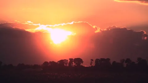 Timelapse of Red Sunset Through Cloud Gap Stock Footage 277363133