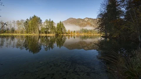 Timelapse with a reflection on a lake in austria Stock Footage 87696650