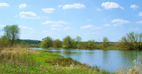 Timelapse: River Flows in Early Spring. the Clouds High Overhead. Fishermen Stock Footage 62777763