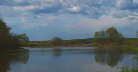 Timelapse: River Flows in Early Spring. the Clouds High Overhead. Fishermen Stock Footage 62778185