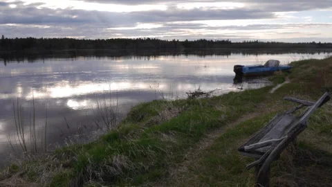 Timelapse on the river shore. Old bench and the boat Stock Footage 269714477