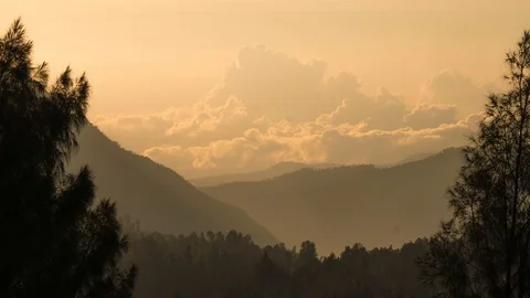 Timelapse of rolling clouds during sunrise near mountain top. 4K UHD. Stock Footage 96341687