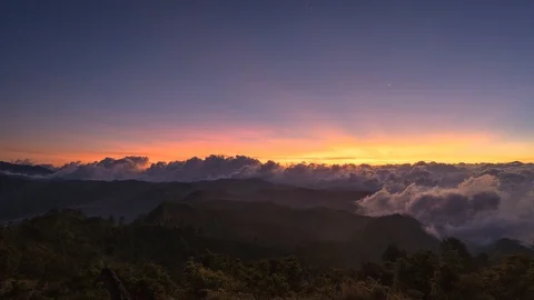 Timelapse of rolling clouds during sunset atop mountain with Venus and moon Stock Footage 96343310