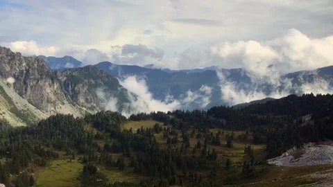 Timelapse of rolling clouds in the mountains of Mt. Rainier National Park	 Stock Footage 99270841