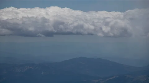 Timelapse of Rolling Clouds over a Distant Mountain Landscape Stock Footage 136921799