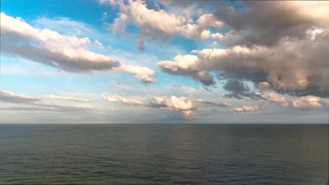 Timelapse of rolling clouds over the sea at sunset Stock Footage 218637219