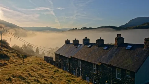 Timelapse of rolling mist over lake and lake land cottages. Stock Footage 118466405