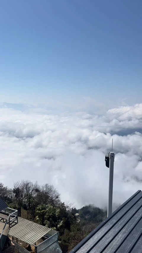 Timelapse Rooftop View of City Skyline Above Flowing Sea of Clouds Stock Footage 329259223