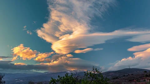 Timelapse of a rotating lenticular-clouds cluster at sunset 4K ProRes 4444XQ Stock Footage 312068916
