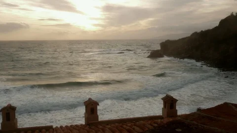 Timelapse Rough sea in front of an ancient italian village at sunset Stock Footage 102053663
