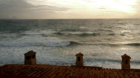 Timelapse Rough sea in front of an ancient italian village at sunset Stock Footage 102053913