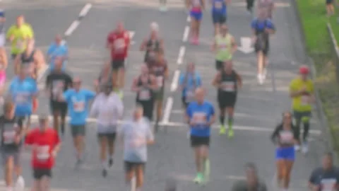 Timelapse of Runners in Marathon Race Passing Quickly with Slow Shutter Speed Stock Footage 346594180