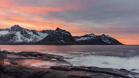 Timelapse of running clouds at sunset over snowy mountains in Senja, Norway Stock Footage 303970794