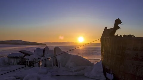 Timelapse of rusty ship on background of frozen Lake Baikal in winter sunset Stock Footage 317302787