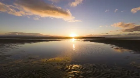 Timelapse of sandy beach at sunset with tide out Video stock 12658813