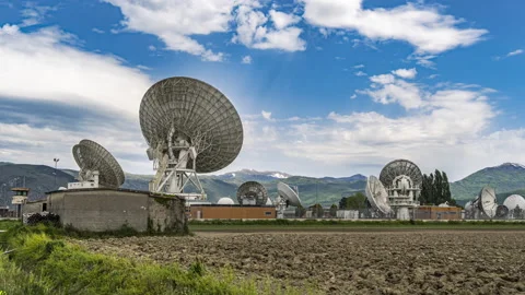 Timelapse of satellite dishes and clouds with mountain landscape Stock Footage 154505875